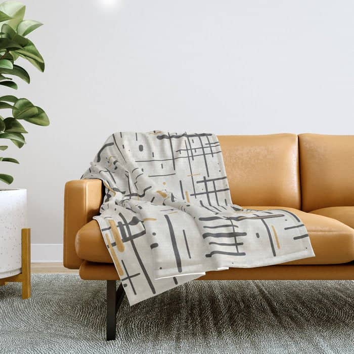 Mid-Century Modern Kinetikos Pattern In Charcoal Gray, Muted Mustard Gold, And Cream Throw Blanket