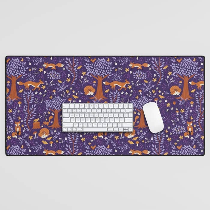 Foxes Playing In A Purple Forest Desk Mat